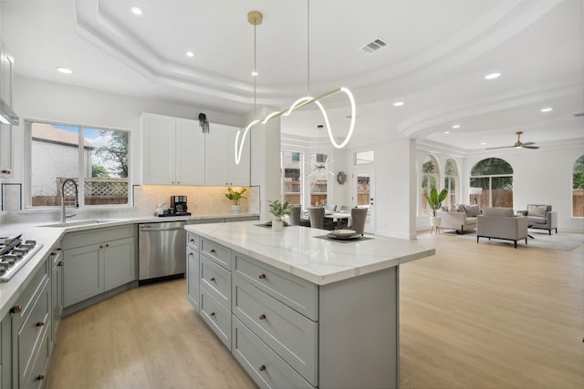 14904 Cordero Dr, Austin, TX 78717 - kitchen with stainless steel appliances, gray cabinetry, a sink, a kitchen island, and recessed lighting