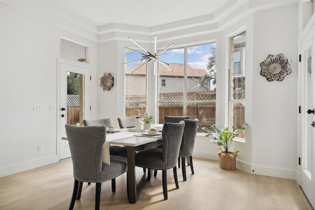 14904 Cordero Dr, Austin, TX 78717 - dining area with light wood finished floors, a chandelier, and baseboards