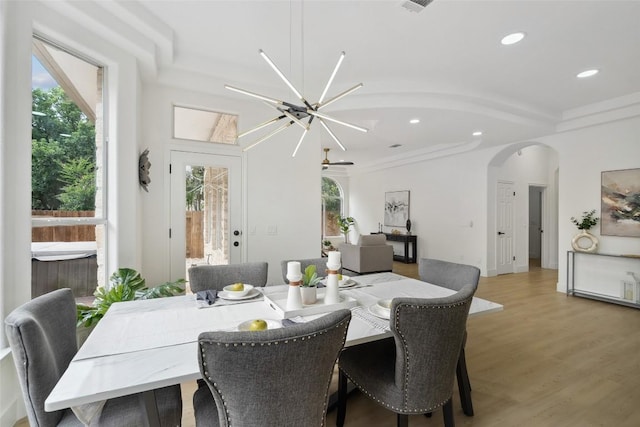 14904 Cordero Dr, Austin, TX 78717 - dining area featuring arched walkways, light wood-type flooring, recessed lighting, and a chandelier