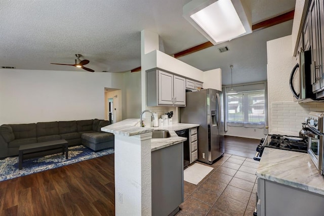 1600 Hatch Rd, Cedar Park, TX 78613 - kitchen with stainless steel appliances, open floor plan, a peninsula, ceiling fan, and a textured ceiling