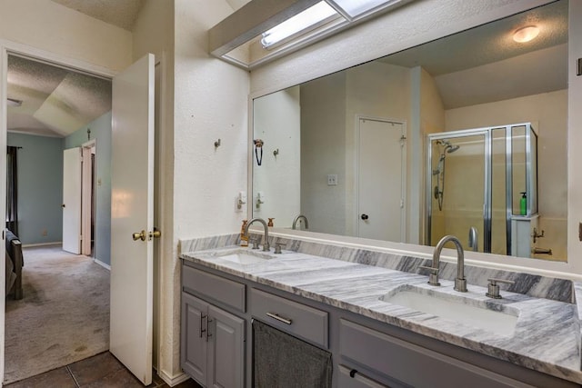 1600 Hatch Rd, Cedar Park, TX 78613 - full bath with double vanity, a stall shower, a textured ceiling, and tile patterned floors