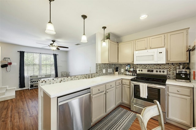 1411 Gracy Farms Ln Unit 69, Austin, TX 78758 - kitchen with appliances with stainless steel finishes, a peninsula, backsplash, a ceiling fan, and recessed lighting