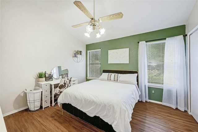 1411 Gracy Farms Ln Unit 69, Austin, TX 78758 - bedroom with wood finished floors, baseboards, lofted ceiling, and ceiling fan