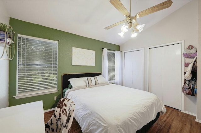 1411 Gracy Farms Ln Unit 69, Austin, TX 78758 - bedroom with vaulted ceiling, wood finished floors, two closets, baseboards, and a ceiling fan