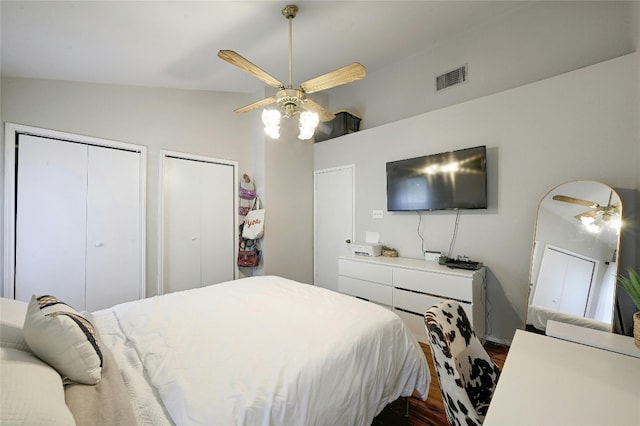 1411 Gracy Farms Ln Unit 69, Austin, TX 78758 - bedroom with dark wood-style flooring, two closets, and a ceiling fan