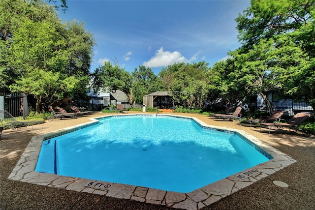 1411 Gracy Farms Ln Unit 69, Austin, TX 78758 - community pool featuring a patio and view of scattered trees