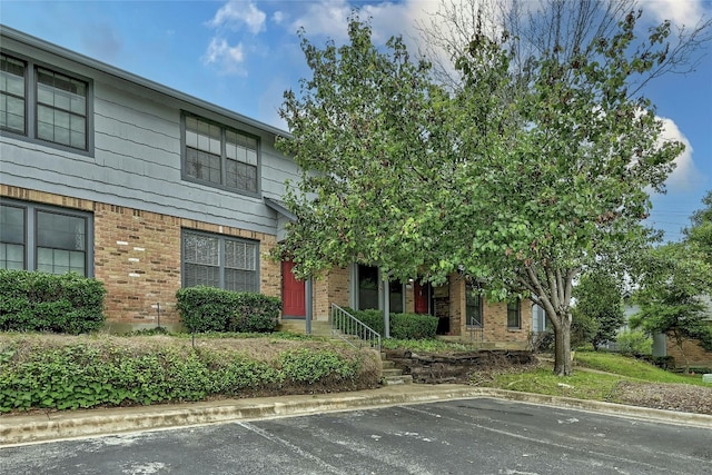 1411 Gracy Farms Ln Unit 69, Austin, TX 78758 - view of front of house featuring brick siding and uncovered parking