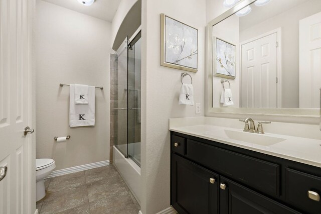 116 Belford St, Georgetown, TX 78628 - full bath with toilet, vanity, shower / bath combination with glass door, and baseboards