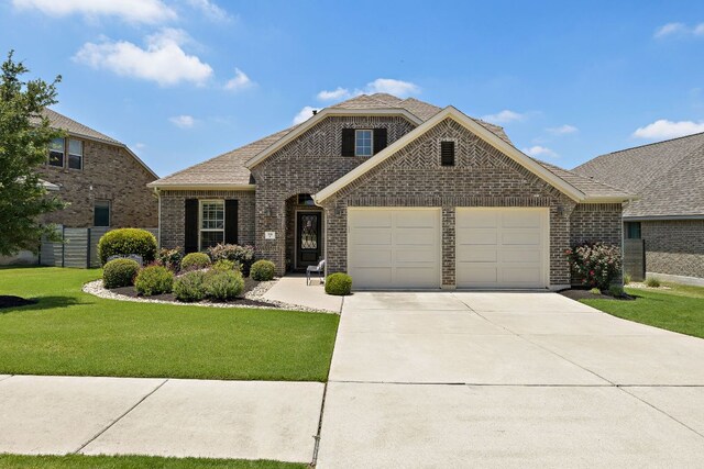 116 Belford St, Georgetown, TX 78628 - view of front facade featuring an attached garage, driveway, and brick siding