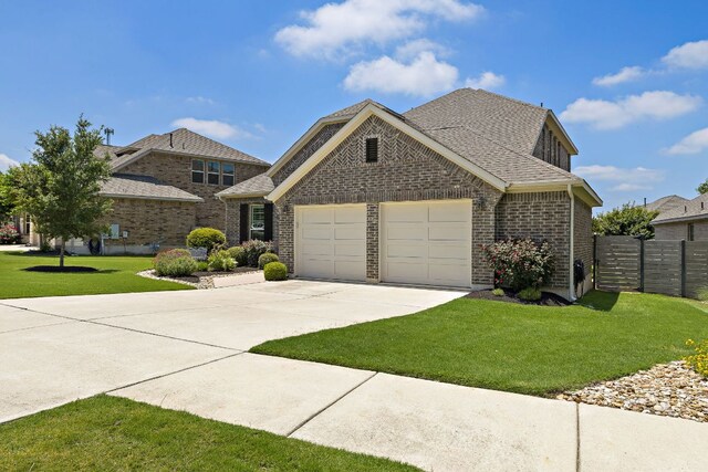 116 Belford St, Georgetown, TX 78628 - traditional-style house featuring a garage, driveway, brick siding, and roof with shingles