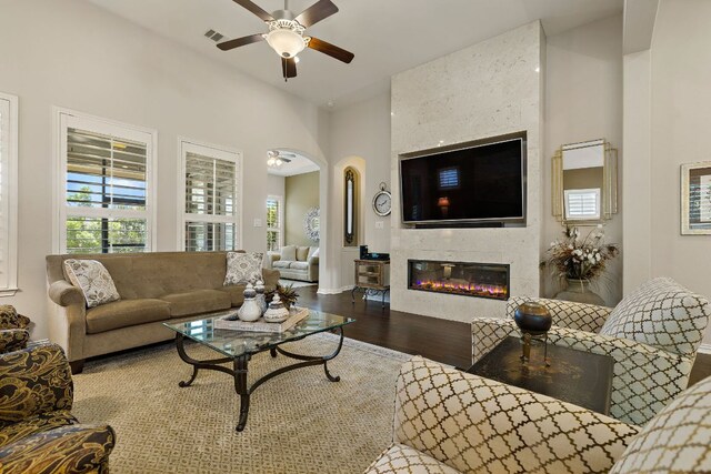 116 Belford St, Georgetown, TX 78628 - living area with ceiling fan, wood finished floors, a large fireplace, and arched walkways