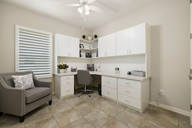 116 Belford St, Georgetown, TX 78628 - office area with built in desk, ceiling fan, baseboards, and stone tile floors