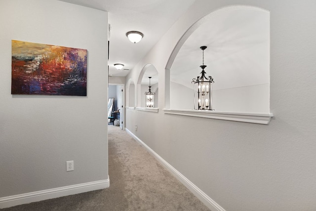 370 Ledge Stone Dr, Austin, TX 78737 - corridor featuring arched walkways, a chandelier, carpet, and baseboards
