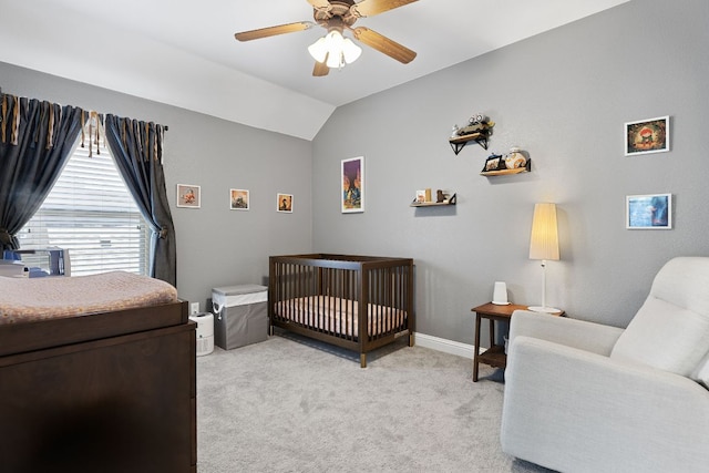 370 Ledge Stone Dr, Austin, TX 78737 - bedroom with light colored carpet, a nursery area, vaulted ceiling, a ceiling fan, and baseboards
