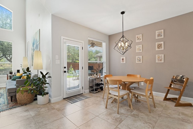 370 Ledge Stone Dr, Austin, TX 78737 - dining space with baseboards, a chandelier, and light tile patterned flooring