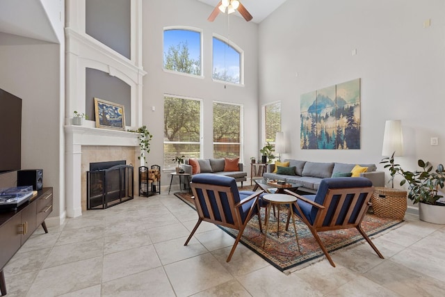 370 Ledge Stone Dr, Austin, TX 78737 - living area with a high ceiling, a ceiling fan, a tile fireplace, and light tile patterned flooring