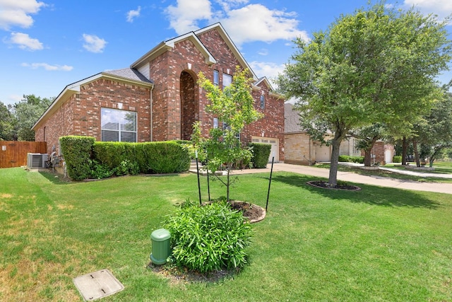 370 Ledge Stone Dr, Austin, TX 78737 - traditional-style home with brick siding, central AC unit, concrete driveway, and a garage