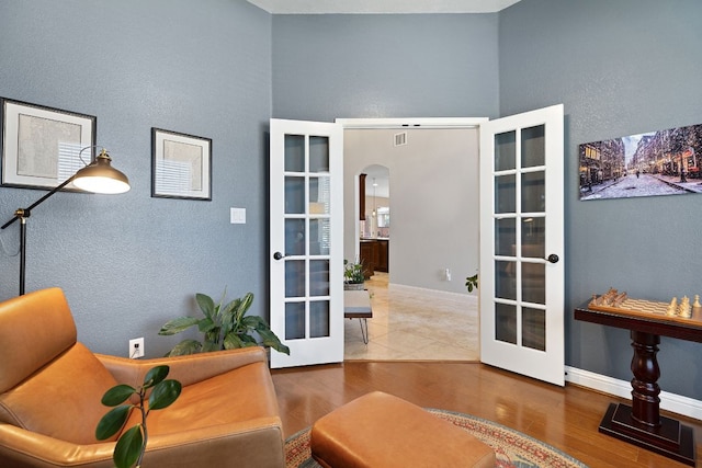 370 Ledge Stone Dr, Austin, TX 78737 - office space featuring french doors, arched walkways, wood finished floors, a high ceiling, and a textured wall