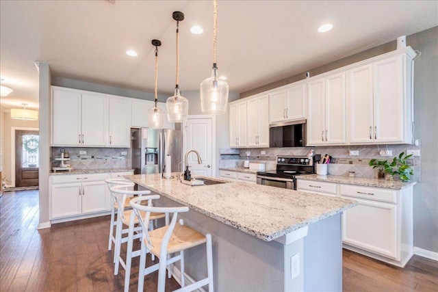 610 Ridge Park Dr, New Braunfels, TX 78130 - kitchen with range with electric cooktop, a sink, stainless steel fridge with ice dispenser, white cabinets, and tasteful backsplash