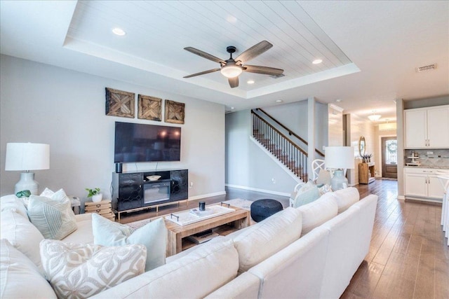 610 Ridge Park Dr, New Braunfels, TX 78130 - living room featuring a tray ceiling, stairway, recessed lighting, a ceiling fan, and hardwood / wood-style floors