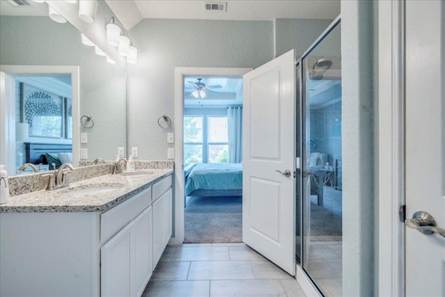 610 Ridge Park Dr, New Braunfels, TX 78130 - bathroom featuring connected bathroom, ceiling fan, double vanity, a textured wall, and a shower with shower door