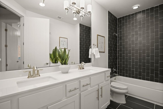 2116 Philomena St, Austin, TX 78723 - bathroom featuring double vanity, toilet, tile patterned floors, and washtub / shower combination