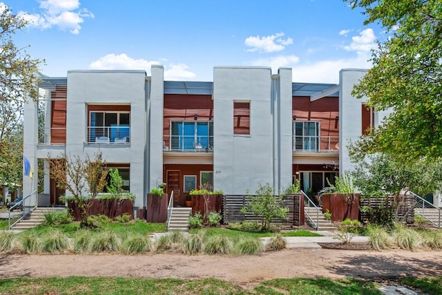 2116 Philomena St, Austin, TX 78723 - view of front of house featuring stairway, a balcony, and stucco siding