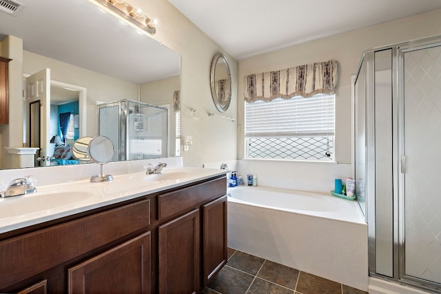 326 Comal Run, Hutto, TX 78634 - bathroom featuring a garden tub, a stall shower, double vanity, and tile patterned floors