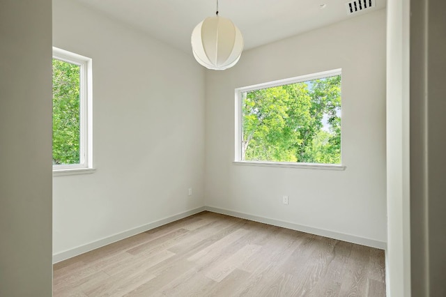 2405 E 22nd St, Austin, TX 78722 - spare room featuring light wood-style flooring and baseboards