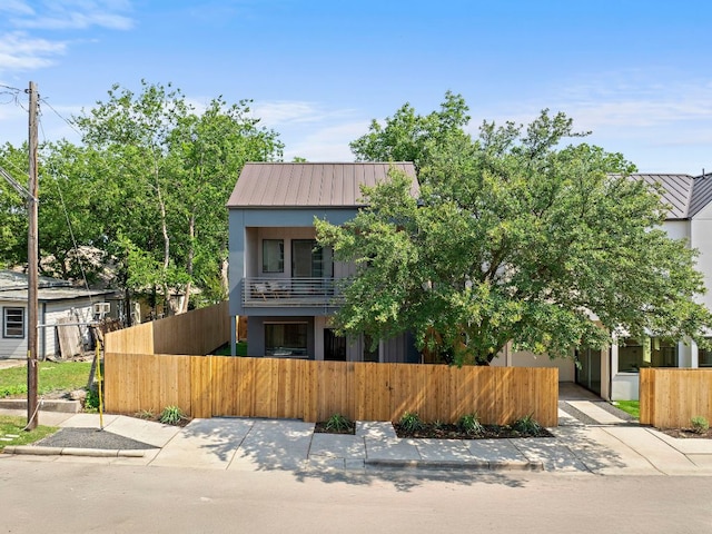 2405 E 22nd St, Austin, TX 78722 - view of front of home with a fenced front yard, a balcony, a gate, and stucco siding