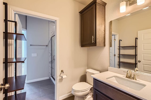 8817 Slater Dr, Austin, TX 78747 - full bathroom featuring a stall shower, toilet, vanity, tile patterned flooring, and baseboards