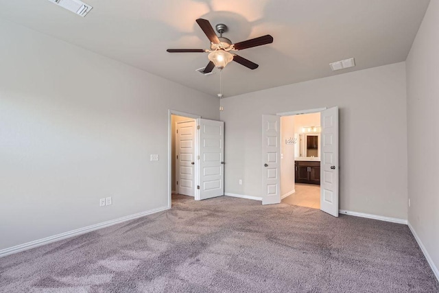 8817 Slater Dr, Austin, TX 78747 - unfurnished bedroom featuring carpet, baseboards, connected bathroom, and ceiling fan