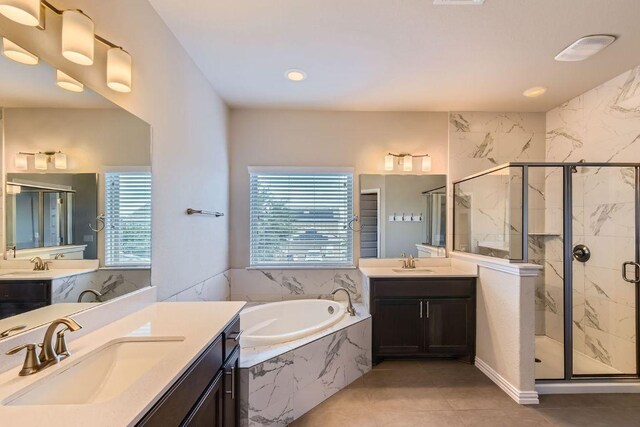 8817 Slater Dr, Austin, TX 78747 - bathroom featuring a bath, a marble finish shower, two vanities, tile patterned floors, and recessed lighting