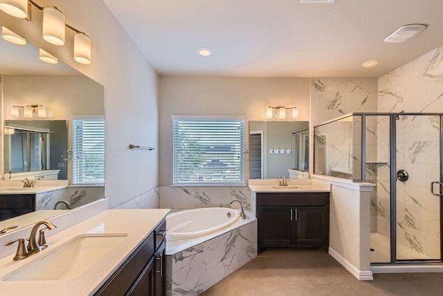 8817 Slater Dr, Austin, TX 78747 - bathroom featuring a garden tub, a marble finish shower, two vanities, tile patterned flooring, and recessed lighting