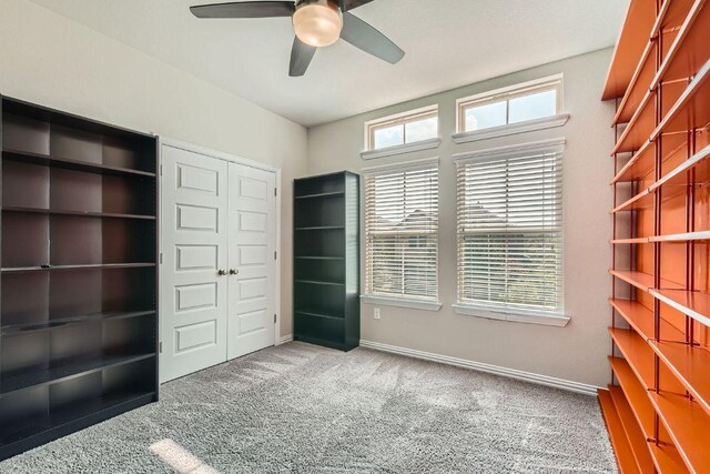 8817 Slater Dr, Austin, TX 78747 - unfurnished bedroom featuring carpet flooring, a closet, baseboards, and ceiling fan