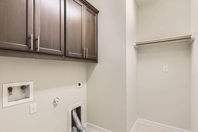 8817 Slater Dr, Austin, TX 78747 - laundry room with electric dryer hookup, cabinet space, hookup for a gas dryer, washer hookup, and baseboards