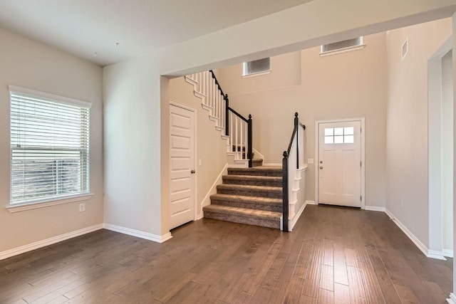 8817 Slater Dr, Austin, TX 78747 - entryway featuring dark wood-type flooring, stairs, and baseboards