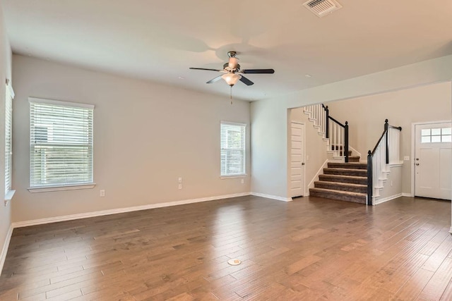 8817 Slater Dr, Austin, TX 78747 - unfurnished living room with stairway, a ceiling fan, and dark wood-style flooring