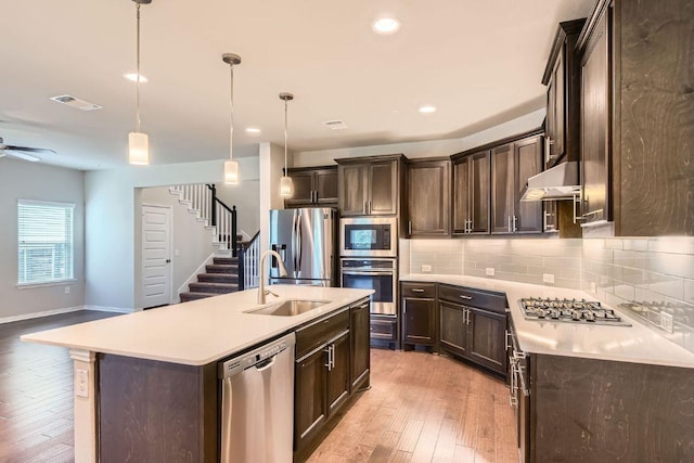 8817 Slater Dr, Austin, TX 78747 - kitchen featuring stainless steel appliances, a sink, dark brown cabinetry, backsplash, and recessed lighting