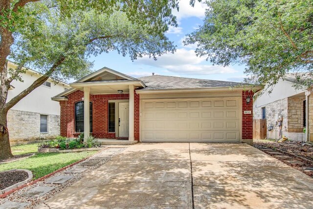1032 Stacias Way, Pflugerville, TX 78660 - single story home featuring concrete driveway, an attached garage, brick siding, and a shingled roof