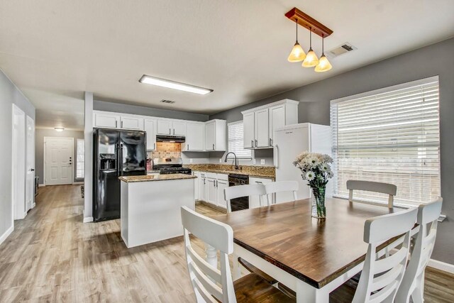 1032 Stacias Way, Pflugerville, TX 78660 - dining room with light wood-style floors and baseboards