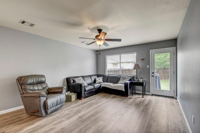1032 Stacias Way, Pflugerville, TX 78660 - living room with light wood-style flooring, ceiling fan, and baseboards
