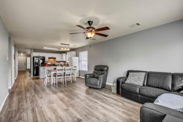 1032 Stacias Way, Pflugerville, TX 78660 - living area with baseboards, light wood finished floors, and ceiling fan
