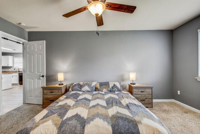 1032 Stacias Way, Pflugerville, TX 78660 - bedroom featuring light colored carpet, a sink, a ceiling fan, and baseboards