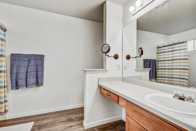1032 Stacias Way, Pflugerville, TX 78660 - full bath with wood finished floors, vanity, baseboards, and a shower with curtain