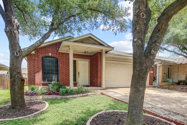1032 Stacias Way, Pflugerville, TX 78660 - ranch-style house with a garage, brick siding, and driveway