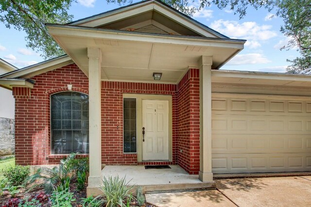 1032 Stacias Way, Pflugerville, TX 78660 - entrance to property with brick siding, an attached garage, and driveway