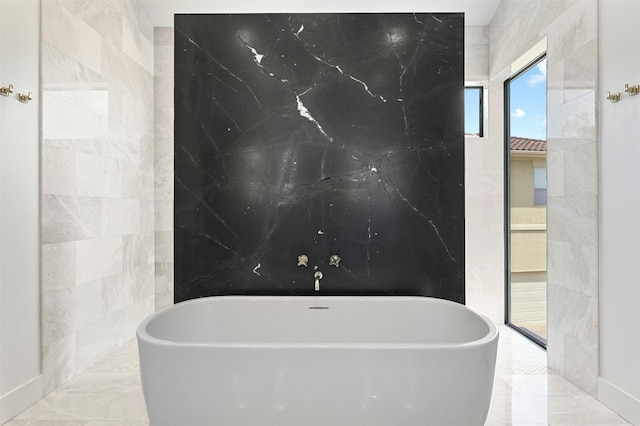 806 Sunfish St, Lakeway, TX 78734 - full bathroom featuring a freestanding bath and tile walls