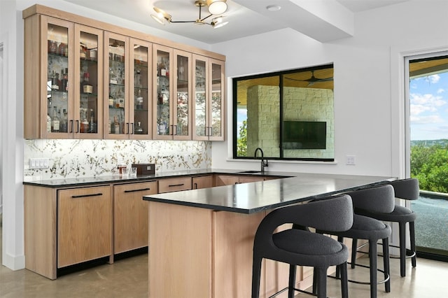 806 Sunfish St, Lakeway, TX 78734 - bar area featuring tasteful backsplash, finished concrete floors, and a chandelier
