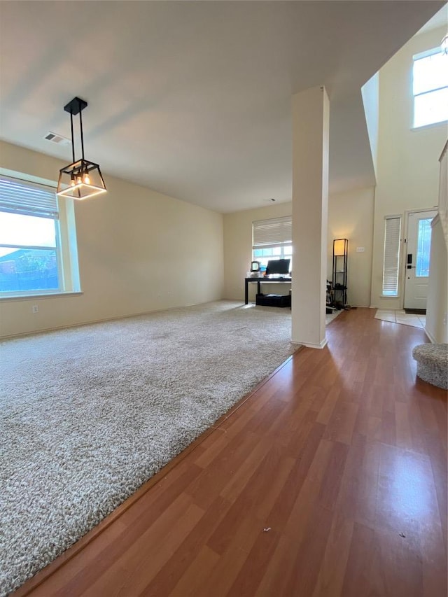 14501 Dreamtime Ln, Pflugerville, TX 78660 - unfurnished living room with wood finished floors and healthy amount of natural light